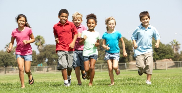 Group Of Children Running In Park