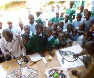 Oogo school children creating their mosaics