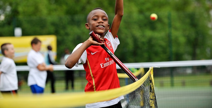 Child enjoying tennis