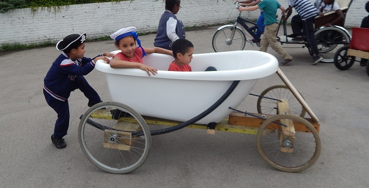 Children playing in go-kart bath tub