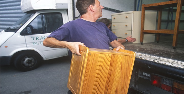 man with chest of drawers