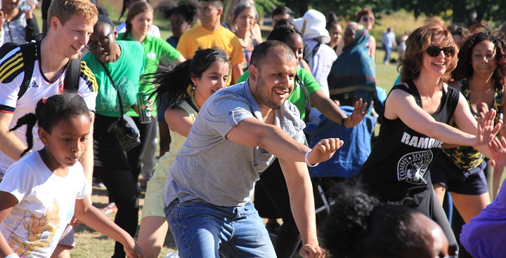 Large group of people exercising in a park