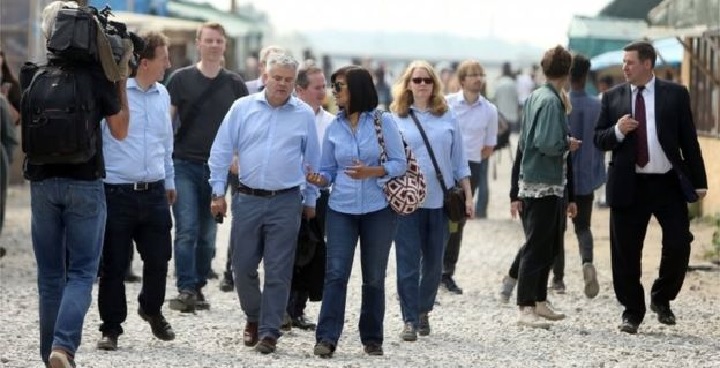 Photo showing Cllr McGlone, as part of the LGA Delegation to Calais, walking through the "Jungle"