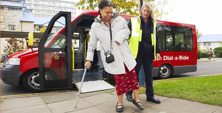 Dial-a-ride travel mentor assisting passenger