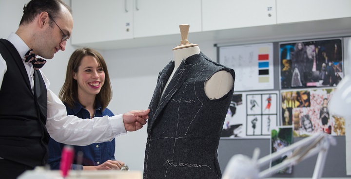 Image from a fashion course at Morley College, two people marking out a top on a tailor's dummy