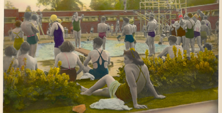 Postcard image of Brockwell Park Lido, taken around 1938. People are sitting around the pool in their swimming costumes