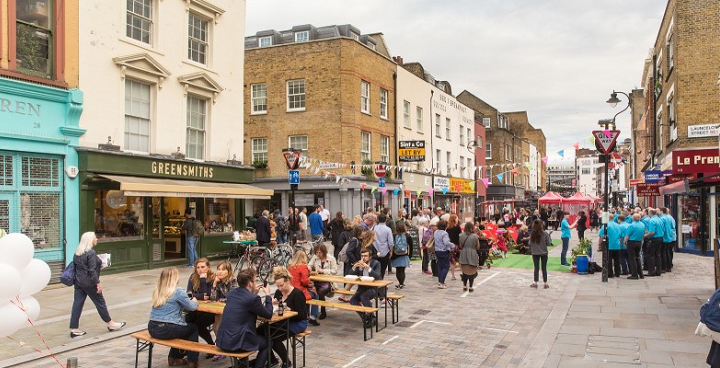 Waterloo streets Lower Marsh and The Cut, a pedestrian street with people sitting on benches eating and drinking