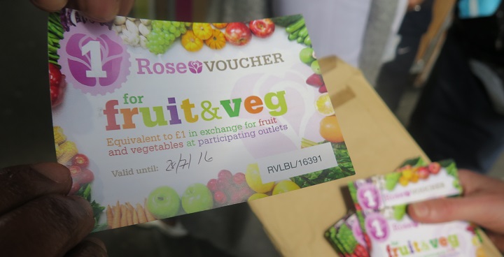 A hand holding a Rose voucher