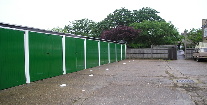 Garages restored with new green doors create extra parking space for Lambeth residents on Hillside Estate