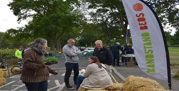 Bandstand beds volunteers (Chair David Dandridge centre with beard) - one using straw bales for seat.
