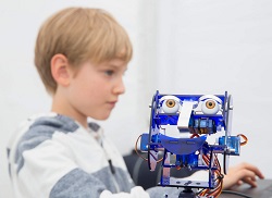 Young boy with a robot at the Institute of Imagination