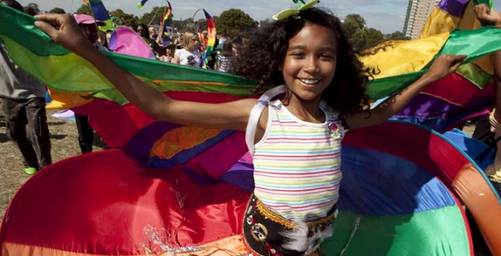 Lambeth Summer Activity Programme 2017 front cover featuring young girl smiling and waving a colourful cloth.