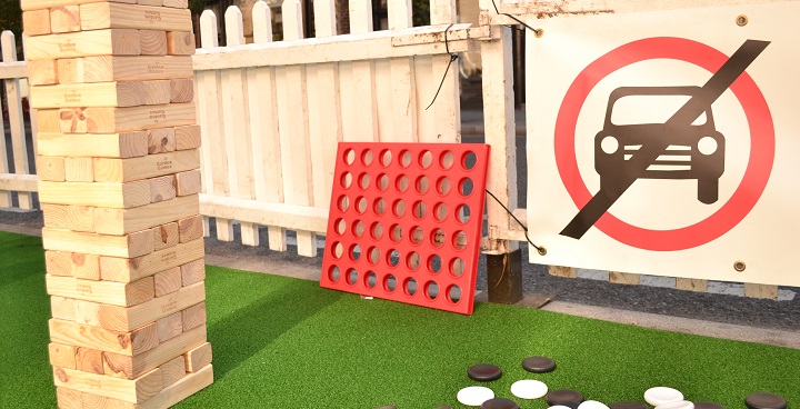 Games set up in the road next to a no cars sign, as part of a previous Car Free Day