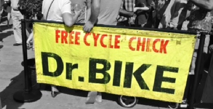 A Dr Bike banner with people standing behind it.