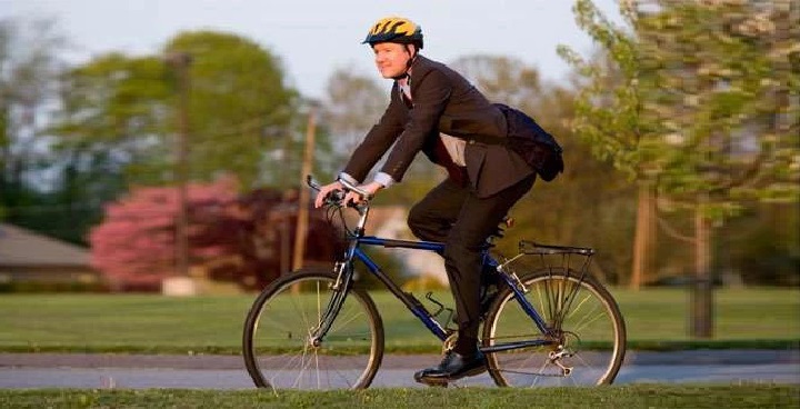 Man riding bike through park