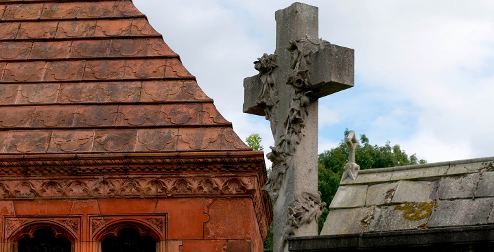 Grey stone cross on Victorian memorial in West Norwood Cemetery