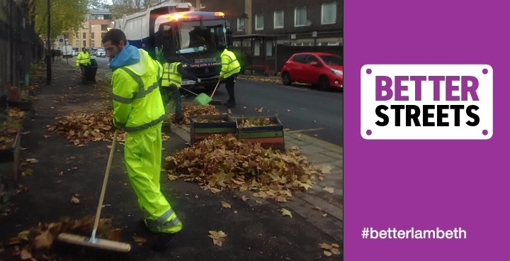 Four road sweepers in yellow high-viz jackets, sweeping leaves into piles ready to be loaded onto truck.