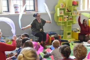 Preschool activities in a library - children playing with feathers