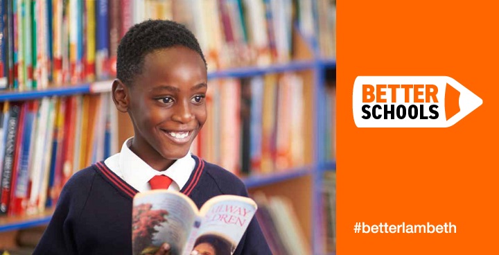 Smiling primary school pupil with book in hand