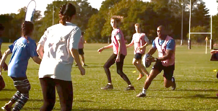 People playing touch Rugby in a park