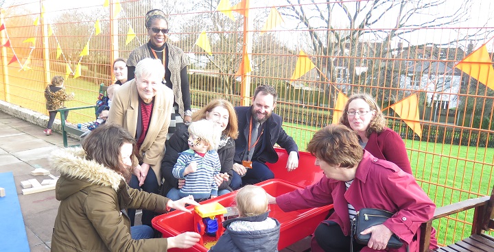 parents, staff and children playing together playing with toys