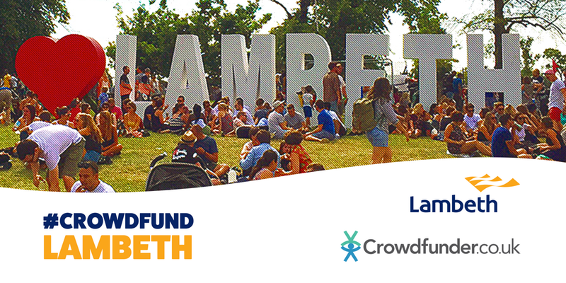 Crowd of people sitting and walking singly and in small groups of two or three by head-hight white Lambeth sign on the grass