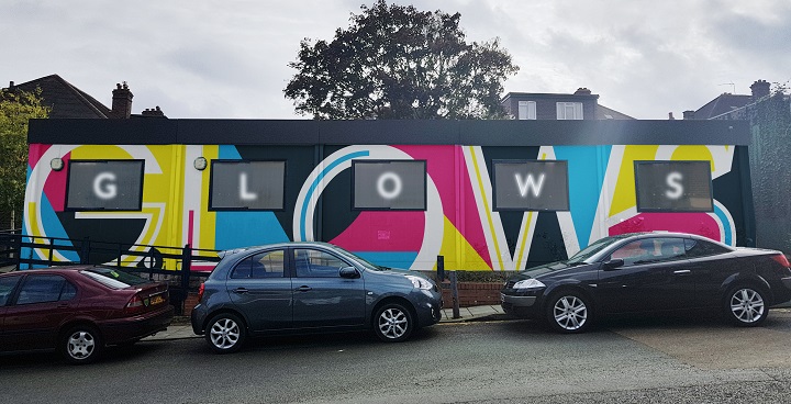 Greenleaf Open WorkSpace - former housing office huts repainted with bright colours and GLOW in white letters