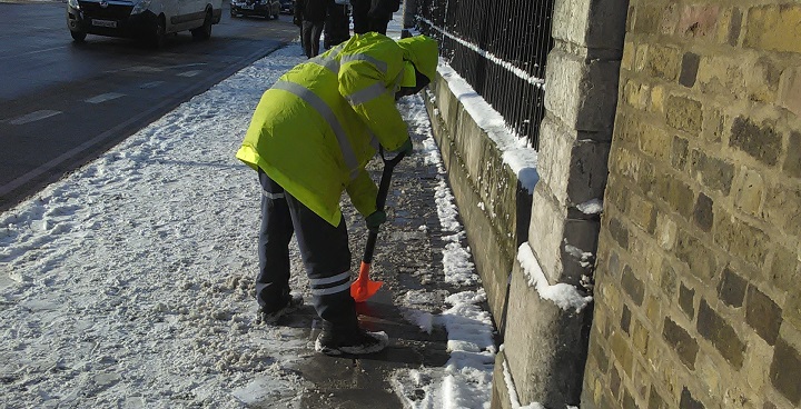 Street cleaner clearing snow from pavements