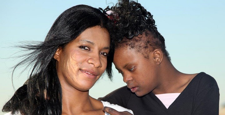 Stock photo of mother and visually impaired teenage daughter