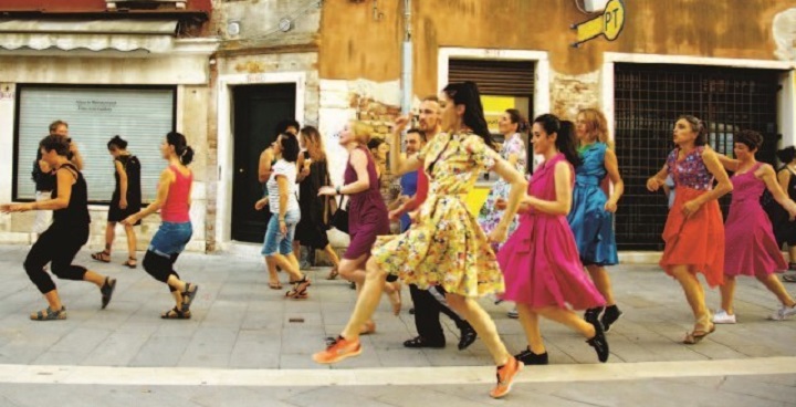 in foreground: woman in yellow dress as part of procession through Spanish streets - event to be recreated in London as part of Art Night procession from Battersea Power Station to Hayward Gallery July 7