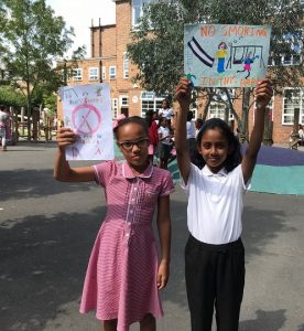 Skye (left) and Divya holding up their designs.