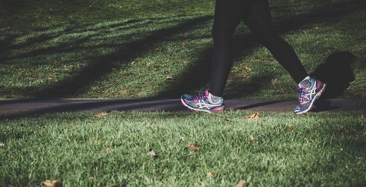 female walking through park