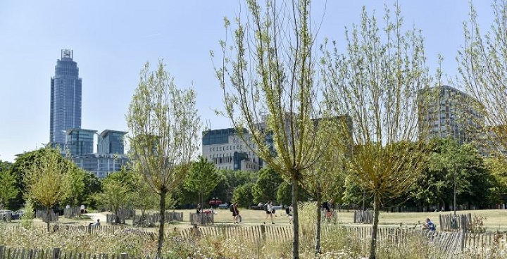 Day lit park with corporate london buildings in background