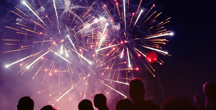 Fireworks display in Brockwell park with heads looking like silhouttes in foreground