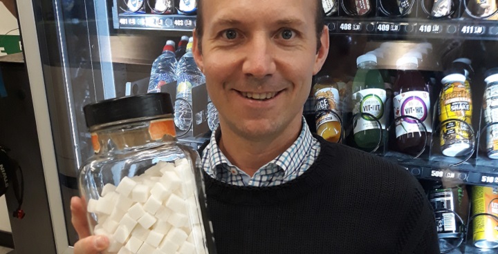 Cllr Davie holds some of the 1000 sugar cubes worth of calories taken out of vending machines in Lambeth Leisure Centres by changing the menu