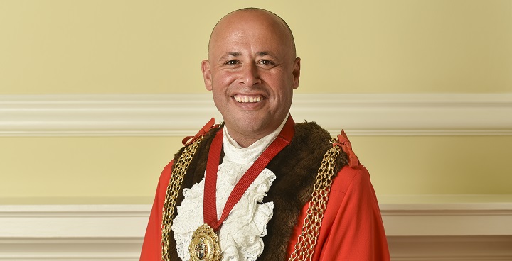 Mayor Wellbelove in red mayoral robes and gold chain of office