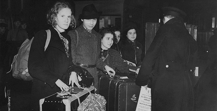 Black & white photo of 1930s girls - Kindertransport: girls passing through customs – ‘torn from home’ World Holocaust memorial day theme for 2019- image © Wiener Library)