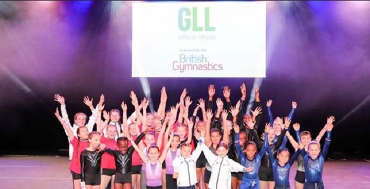 Young Gymnasts throw their arms in the air to celebrate a new partnership between Lambeth leisure centres and British Gymnastics to get more people involved in the sport and talent-spotted early