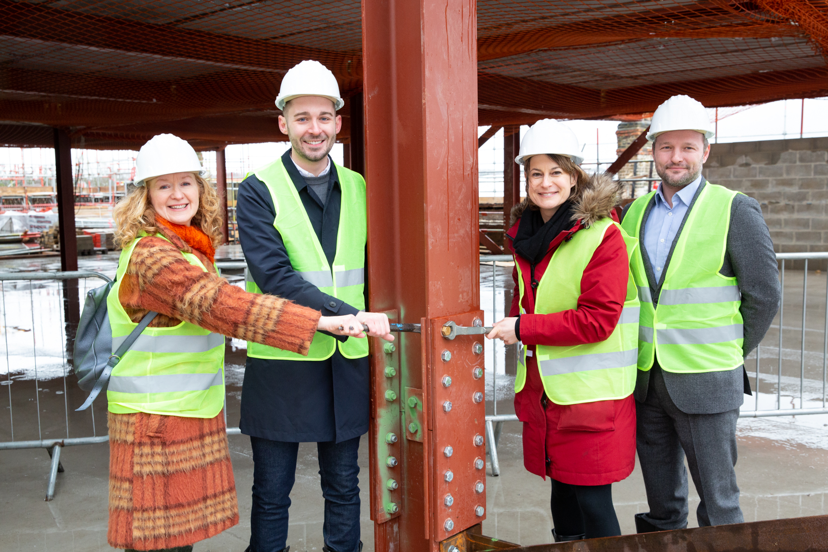 Coldharbour councillor Scarlett O'Hara, Cabinet Member for Planning, Investment and New Homes Matthew Bennett, Dulwich & West Norwood MP Helen Hayes, and Lambeth Council leader Jack Hopkins, help to tighten the ceremonial bolt in the new Ovalhouse Theatre