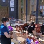 masked volunteers pack care packages at the Black Prince Trust