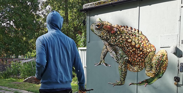 Street artist ATM paints a tao on the volunteer hit in Ruskin Park