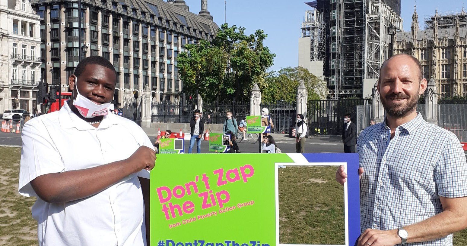 Don't zap the zip! Cllr Ed Davie and Joshua Brown Smith with a sign at the protest in Parliament Square