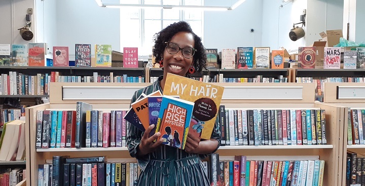 Librarian Zoey with a handful of books for young black readers