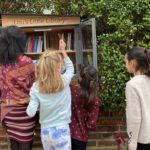 children leave and borrow books at Lou's Little Library