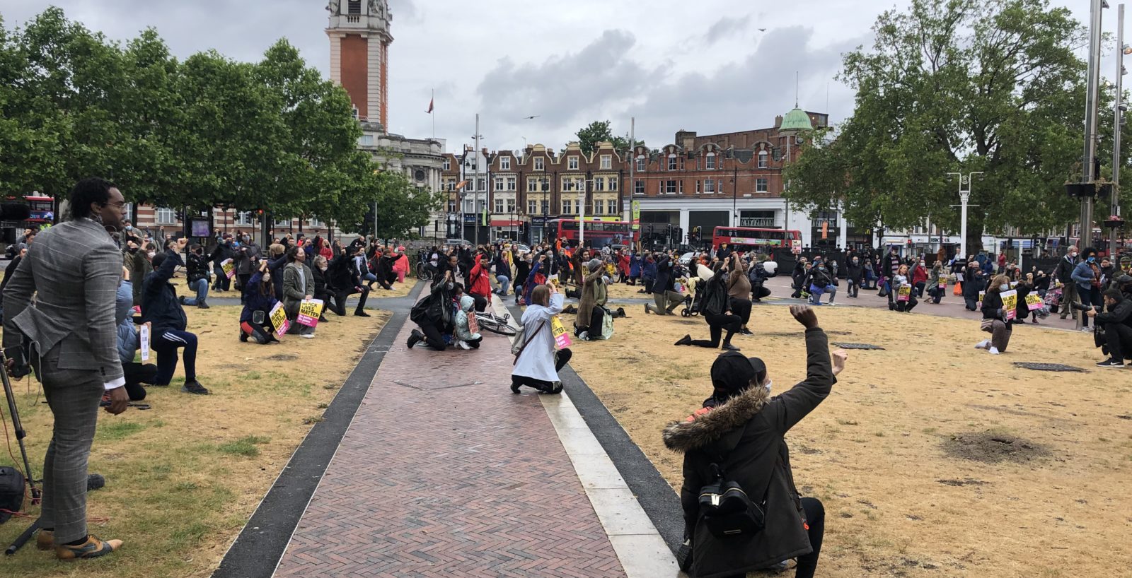 People take the knee at a Black lives matter protest in Windrush Square