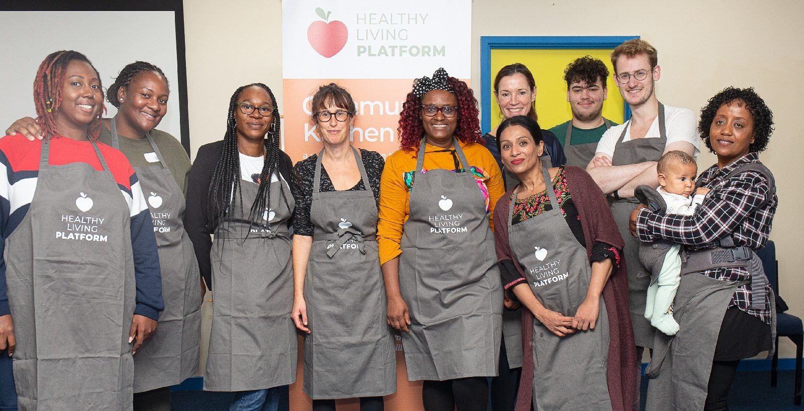 Healthy Living Platform kitchen team in grey aprons