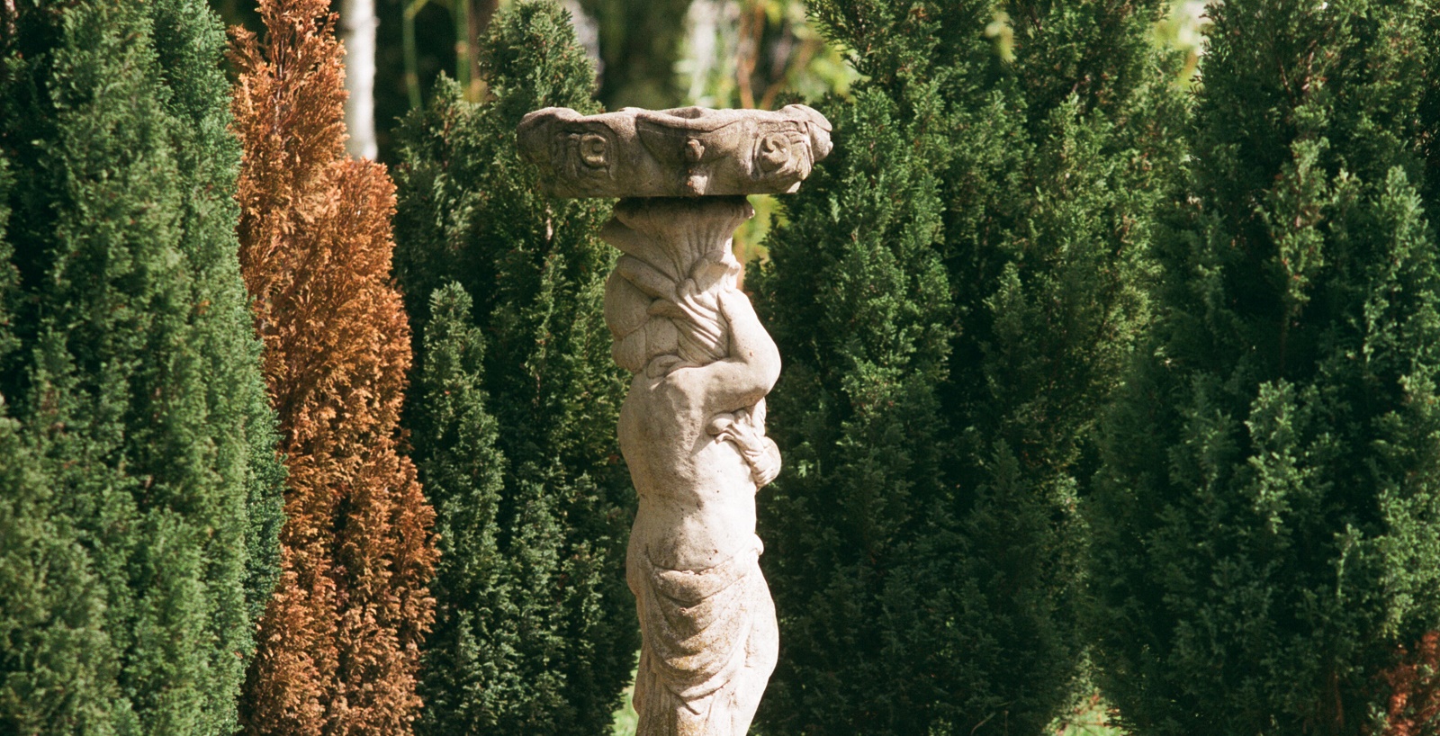 monument /fountain in the shape of a greek classical statue of a woman in Lambeth Crematorium grounds