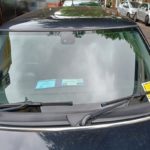 windscreen of car with blue badge and penalty notice