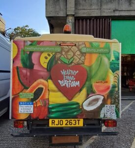 Huey the milk float decorated in the style of the surplus food hub mural