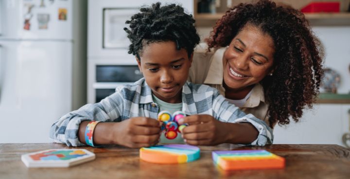 Carer and child play with sensory toys